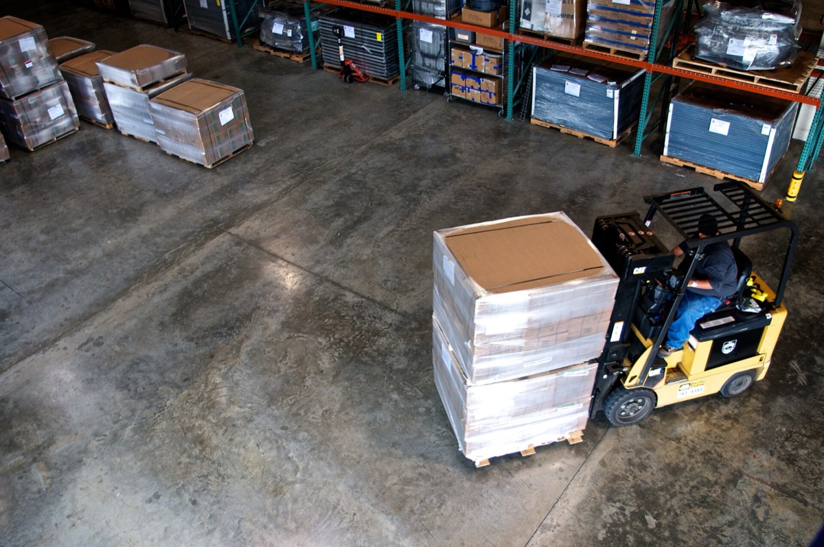 Forklift organising palletised goods in a distribution centre