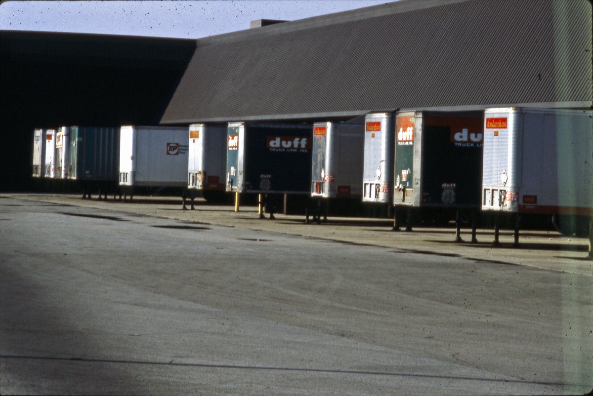 Row of freight trailers at a logistics loading dock
